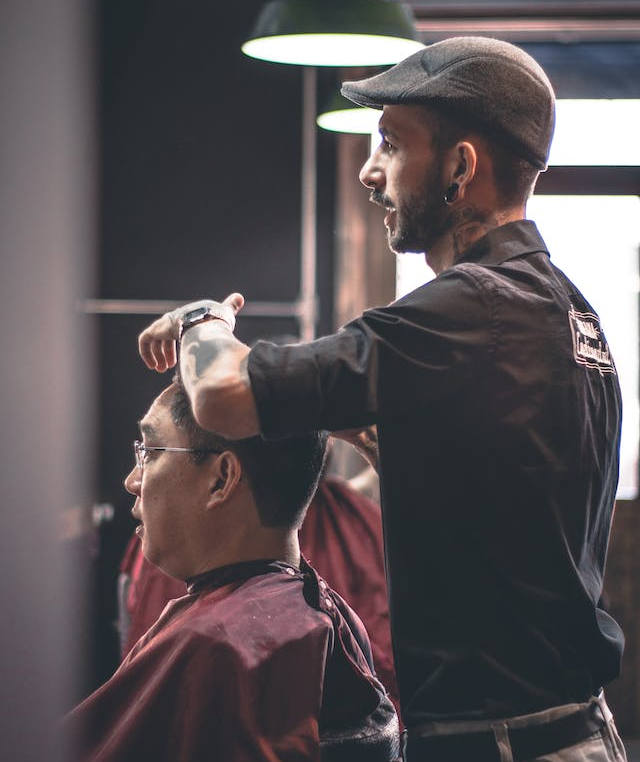 barber is shaving customer